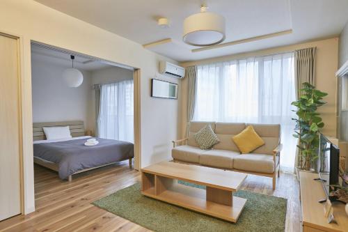 a living room with a bed and a couch at PINN-N4E2Ⅱ in Sapporo