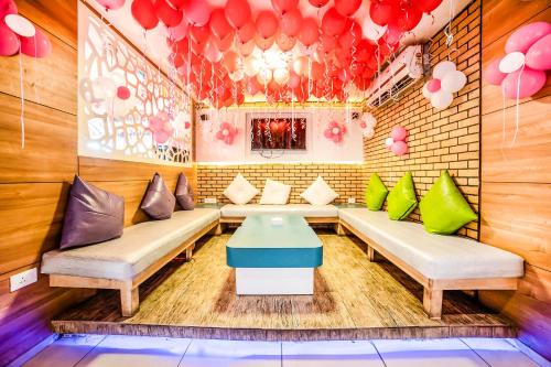 a room with couches and a table and balloons at FabHotel Imperio - Nr Baner Hill in Pune