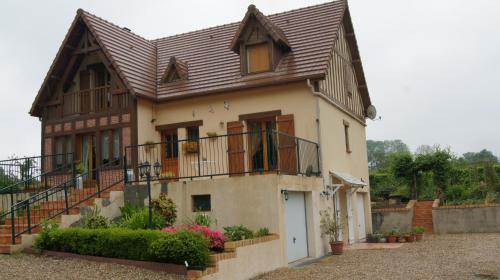 a house with a metal roof and a balcony at Chambres d'Hôtes de Boudeville in Boudeville