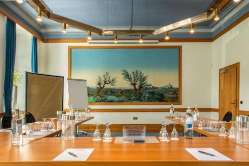 a conference room with a large painting on the wall at Hotel Schloss Hornberg in Hornberg