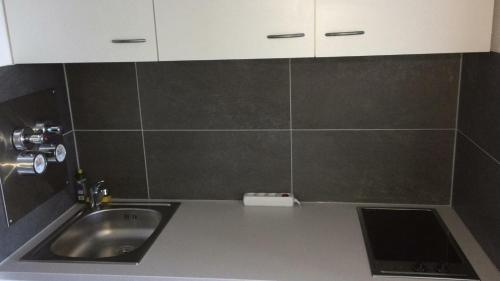 a kitchen with a sink and a counter top at FeWo Köln in Cologne