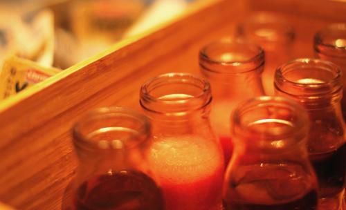 a group of glass bottles sitting on a shelf at South Pacific Hotel in Hong Kong
