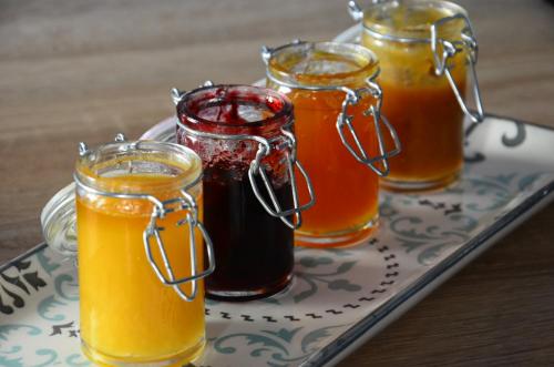 four jars of honey on a tray on a table at LES AUGUSTINS, chambres d'hôtes, quartier historique, accueil 2 roues in Angers