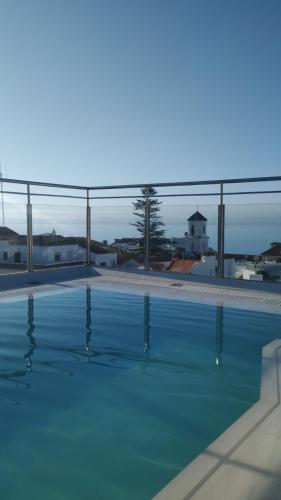 a large swimming pool with blue water at Mena Plaza in Nerja