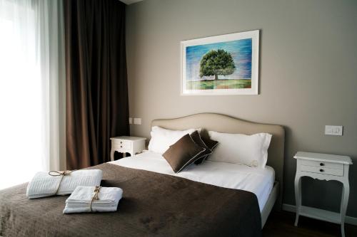 a hotel room with a bed and a tree at San Marco Antico Relais - B&B in Bitonto