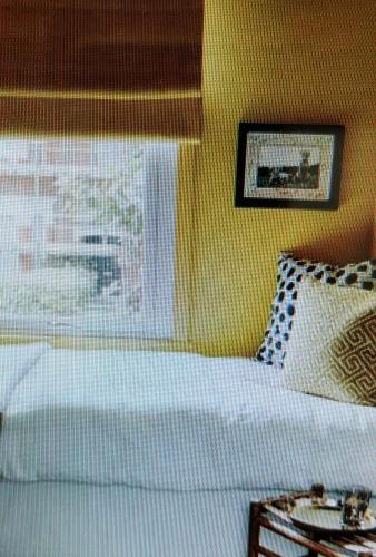 a bedroom with a white bed and a window at angolo23 in San Benedetto del Tronto