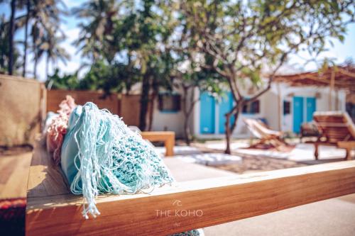 a bag sitting on top of a wooden bench at The Koho Air Hotel in Gili Air