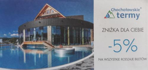 a sign for a building with a swimming pool at Apartament we Wsi in Chochołów
