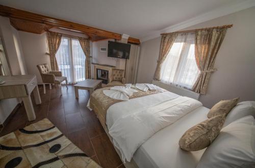 Postel nebo postele na pokoji v ubytování Ağva Carpediem Otel