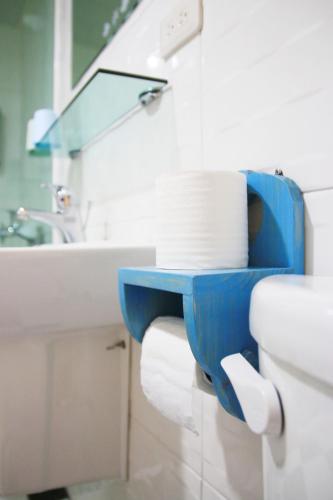 a bathroom with a toilet with a blue shelf on it at The Wind BnB Ⅱ in Budai