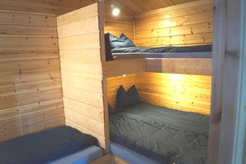 a wooden cabin with two bunk beds in it at Myrkulla Lodge in Jerfojaur