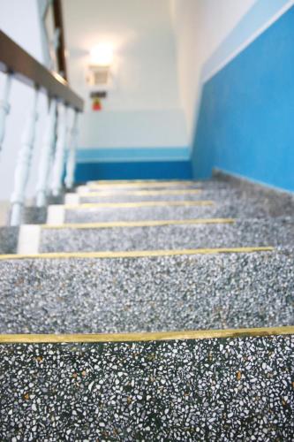 a hallway with stairs and a blue wall at The Wind BnB Ⅱ in Budai