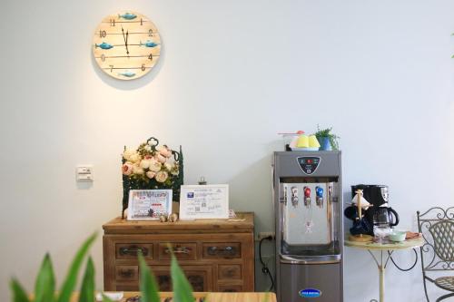a kitchen with a refrigerator and a wooden cabinet at The Wind BnB Ⅱ in Budai