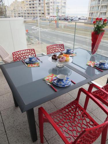 a table with a plate of food on it at Osea Oostende in Ostend