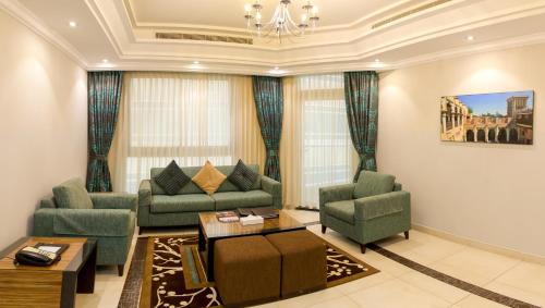 a living room with two couches and a table at Al Majaz Premiere Hotel Apartments in Sharjah