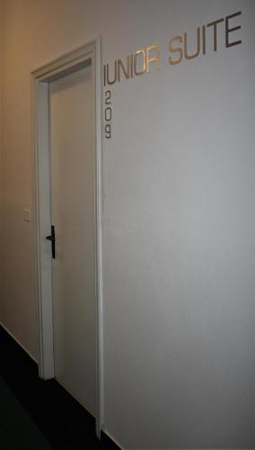 an elevator door with a sign on the wall at Albergo Ristorante Miramonti Toano in Toano