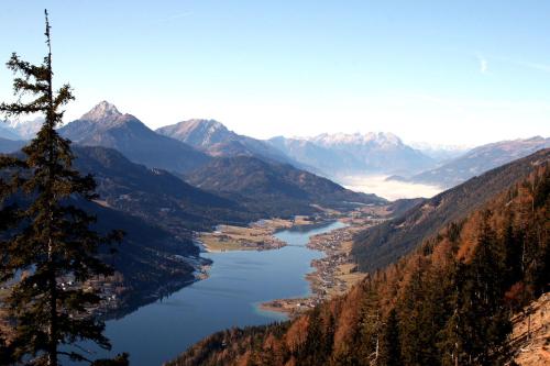 a view of a river in a valley with mountains at Seehaus Winkler in Weissensee