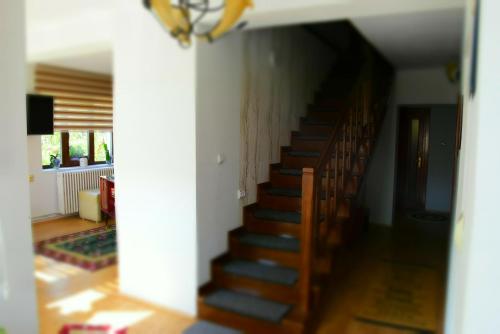 a staircase in a living room with a stair case at Casa Smeilor Horezu in Horezu