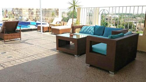 a patio with couches and a table on a balcony at Thebes Hotel in Luxor