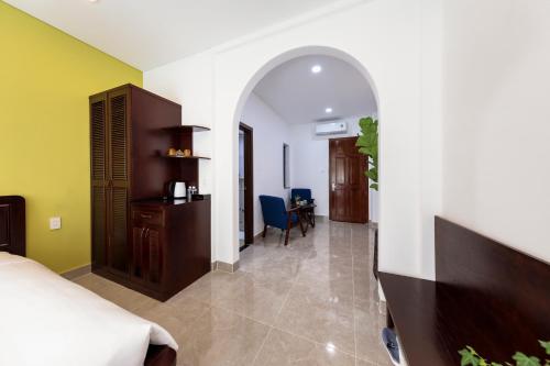 a bedroom with a bed and a desk and a chair at Chez Mimosa Petite - Free Laundry in Ho Chi Minh City