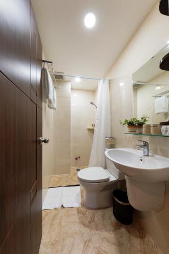 a bathroom with a white toilet and a sink at Chez Mimosa Petite - Free Laundry in Ho Chi Minh City