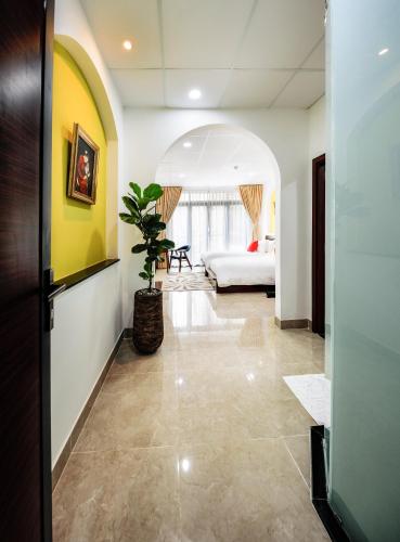 a hallway with a room with a bed and a plant at Chez Mimosa Petite - Free Laundry in Ho Chi Minh City