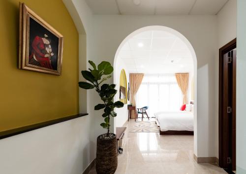 a hallway with a room with a bed and a plant at Chez Mimosa Petite - Free Laundry in Ho Chi Minh City
