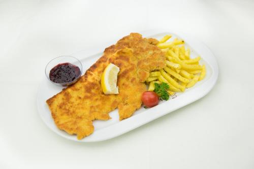 a plate of food with fish and french fries at Hotel Toggenburgerhof in Kirchberg