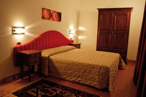 En eller flere senge i et værelse på Hotel Al Barco