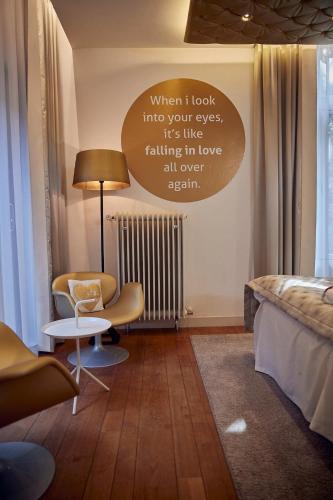 a bedroom with a bed with a sign on the wall at Landgoed Groot Warnsborn in Arnhem