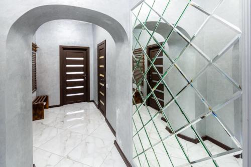 a hallway with a door and a glass wall at Apartment with 2 bedroom near Opera House Gorodotska 27 str with parking in Lviv