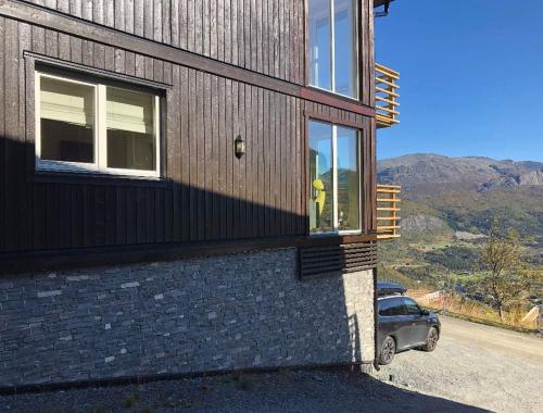 a person standing in a window of a house at Skarsnuten Panorama 61, Hemsedal in Hemsedal