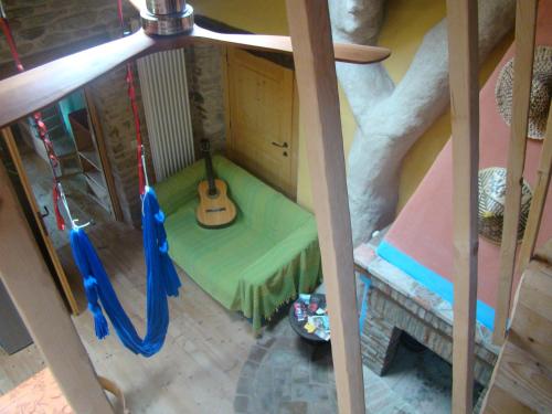 a room with a swing with a guitar in it at Casa della Casa in San Severino Marche