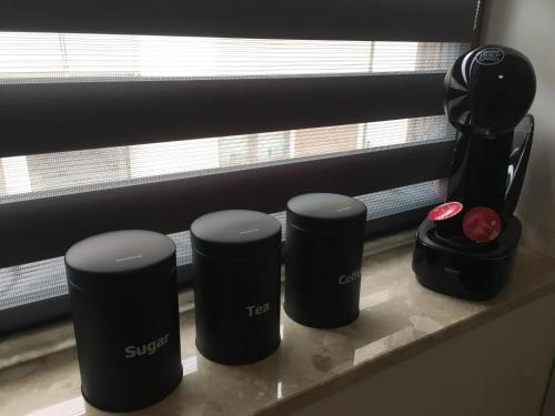a counter with three black objects on a window sill at Studio Fibra Gusto in Rybnik