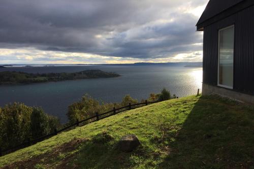a house on a hill with a view of a lake at Casa La Trafa in Futrono