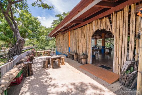 a pavilion with wooden benches and tables on it at Balbo's in Liberia