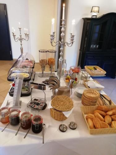 a table with bread and other food items on it at dS Hotel Gronau in Gronau