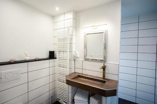 a bathroom with a sink and a mirror at Bergoase in Bad Lauterberg