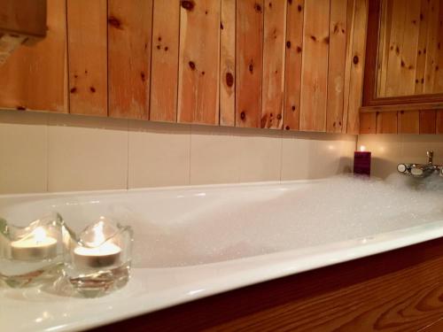 a bath tub filled with water in a bathroom at Appartement Val d'Isère 6 personnes avec parking in Val dʼIsère