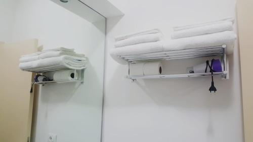 a stack of towels on a shelf in a room at Brezza Marina in Sapri