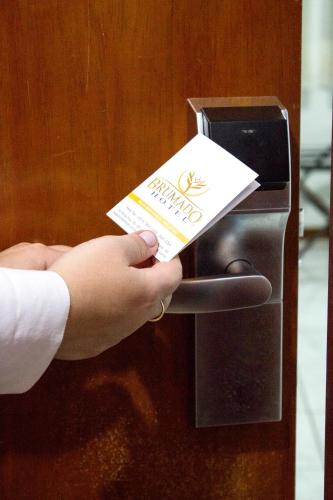 a person is putting a card in a card reader at Brumado Hotel in Campo Grande