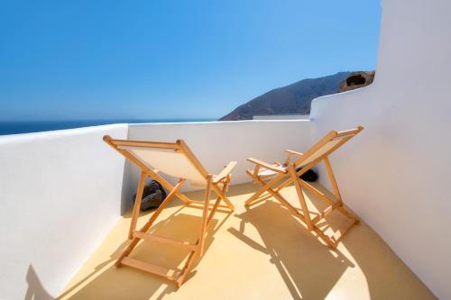 two chairs sitting on the roof of a house at Oikia Cave House in Éxo Goniá