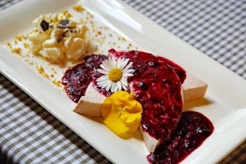 a white plate with desserts on a table at Hotel Tripič, restaurant and pizzeria in Bohinj