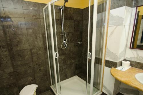 a bathroom with a shower with a toilet and a sink at Grand Hotel Tamerici & Principe in Montecatini Terme