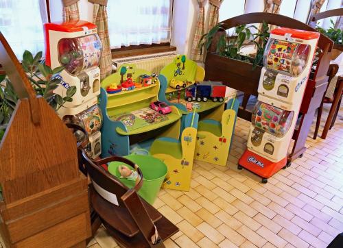 a childs play area with toys in a room at Hotel Tripič, restaurant and pizzeria in Bohinj