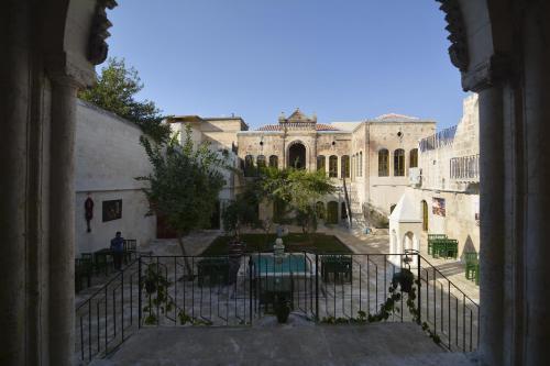 an entrance to an old building with a fence at HANEHAN in Urfa