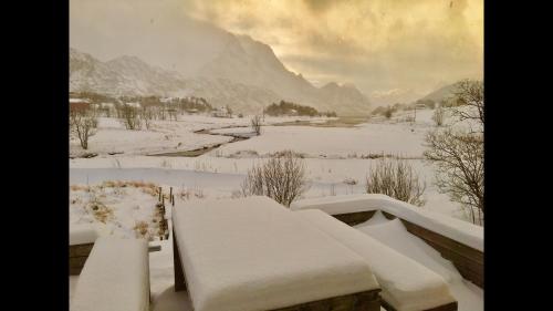 a view of a snow covered valley with a mountain at Lofoten Fjord Lodge in Saupstad