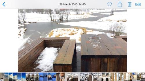 a picture of a wooden bench in the snow at Lofoten Fjord Lodge in Saupstad