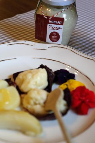 a plate of food on a table with a plate of food at Hotel Tripič, restaurant and pizzeria in Bohinj