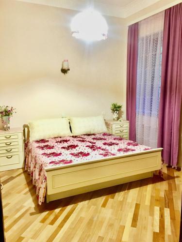 a bedroom with a bed and two dressers at Beauty in the Heart of the City in Tbilisi City